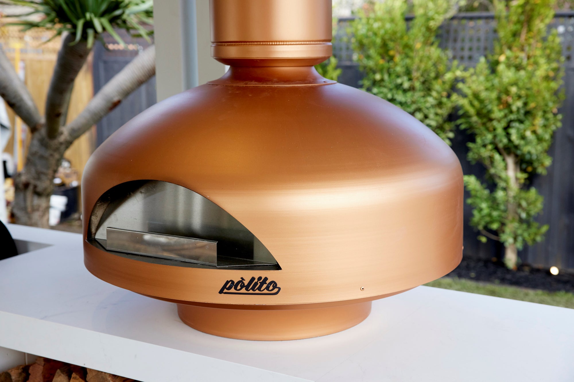 copper color polito giotto wood fired oven with benchstand at the block tv show