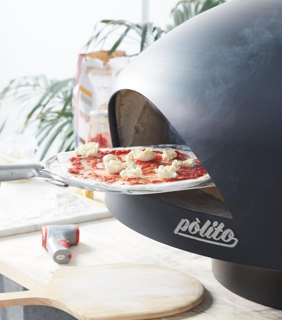 polito giotto wood fired pizza oven in black with benchstand with pizza peel